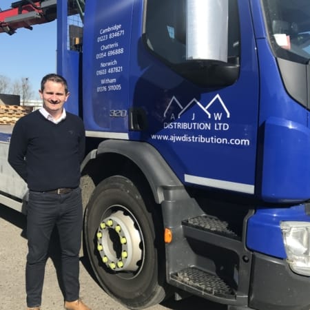 Image of a man standing next to a lorry